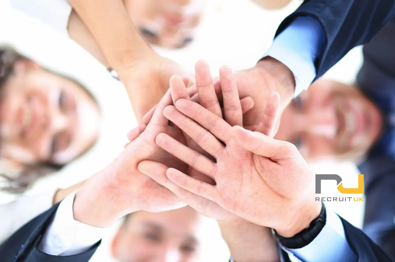 Pictures of a team with their hands in the middle, on top of each other